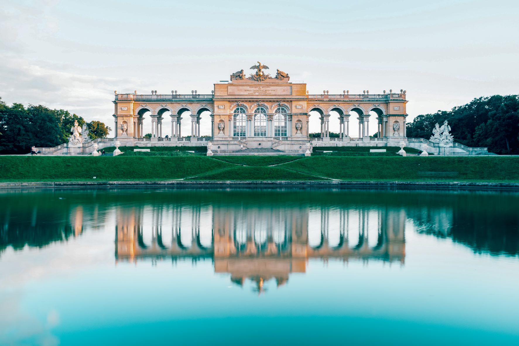 The Gloriette Pavilion features a stunning, blue pond and stylish architecture.