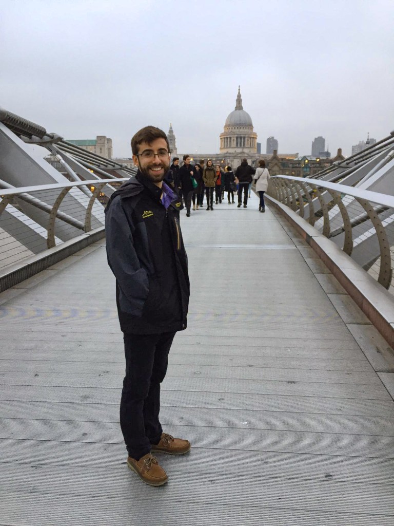 A picture of Andrew smiling on a famous bridge in London.
